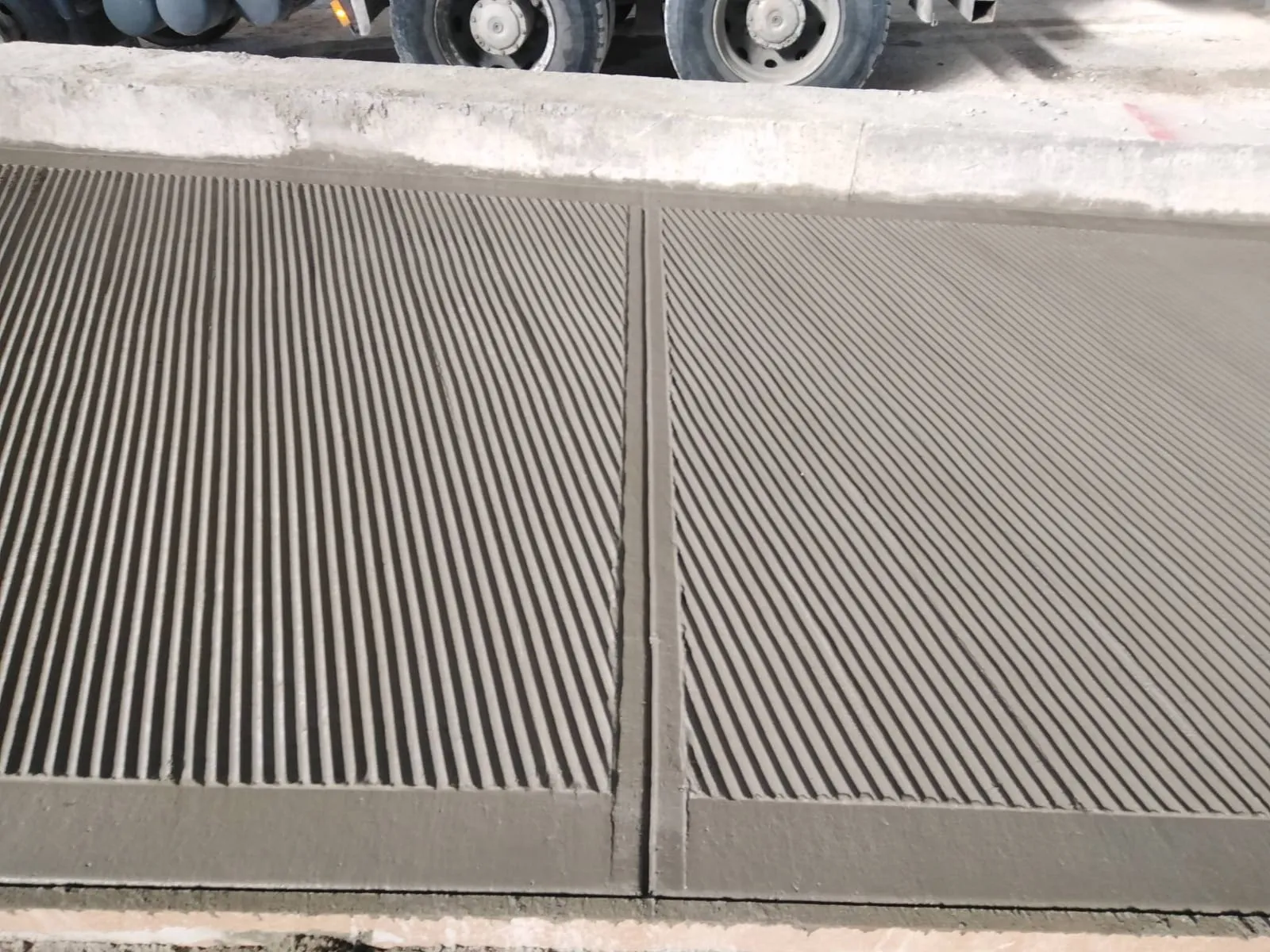 Close-up of broomed finish concrete pad panels by Concrete Star Calgary