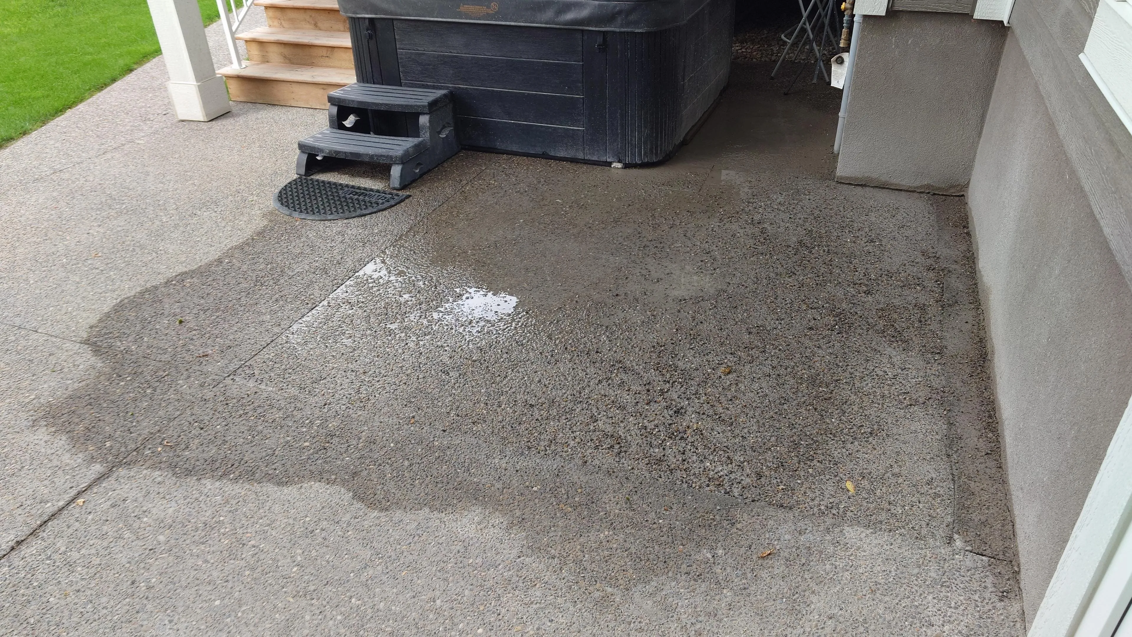 Exposed aggregate concrete patio with hot tub area installed by Concrete Star in Calgary