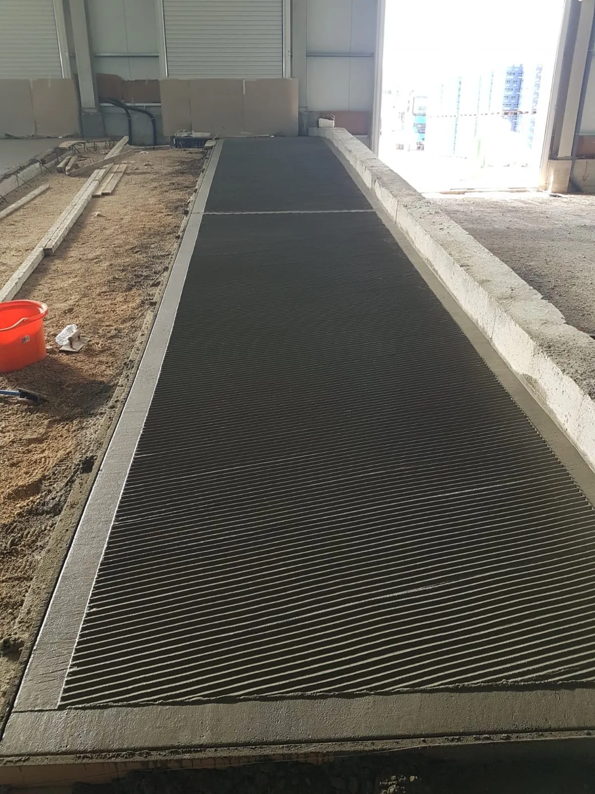 Angled view of a grooved concrete barn floor slab by Concrete Star Calgary