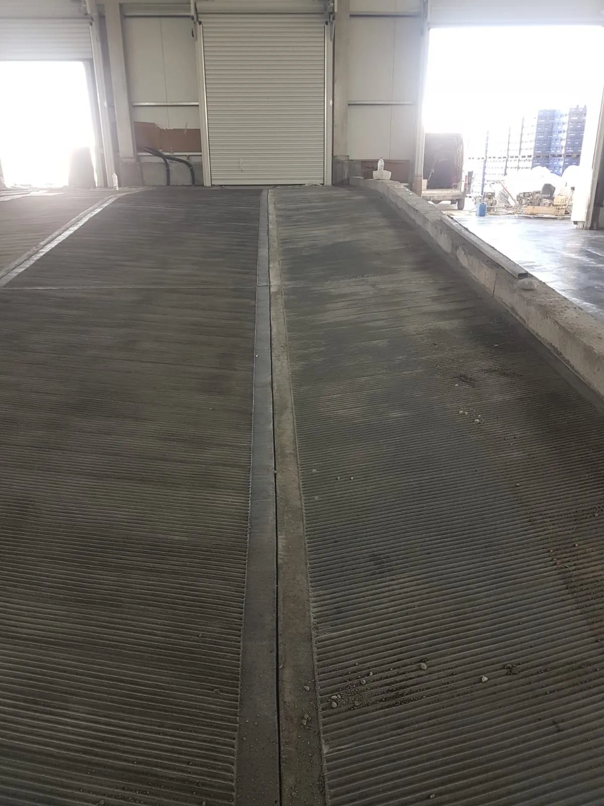 Concrete loading ramp with grooved finish inside a commercial building by Concrete Star Calgary