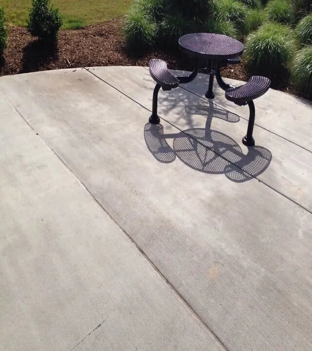 metal table on a concrete patio line joints separated in Calgary