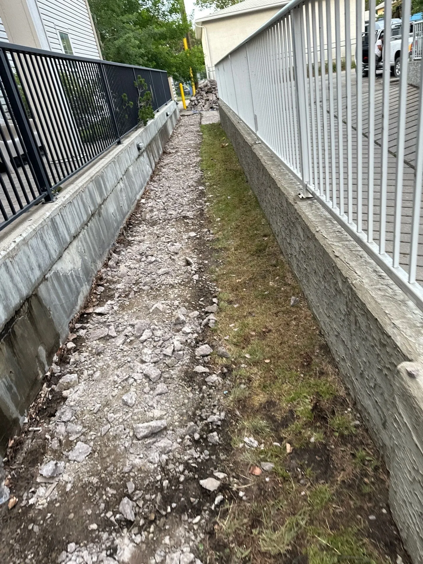 Walkway between railings with concrete fully removed at Bannister Rd SE, Calgary