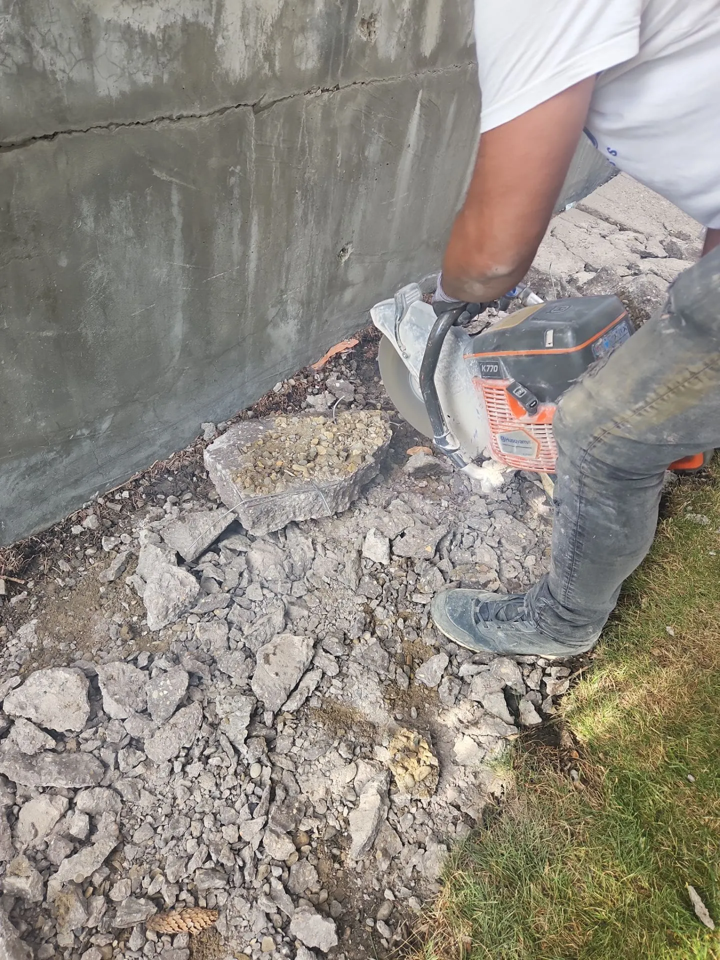 Concrete Star crew sawing concrete along building wall on Bannister Rd SE in Calgary