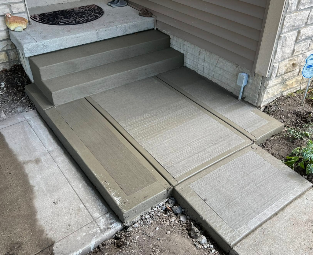 Concrete front steps and landing with clean control joints at a Calgary home by Concrete Star