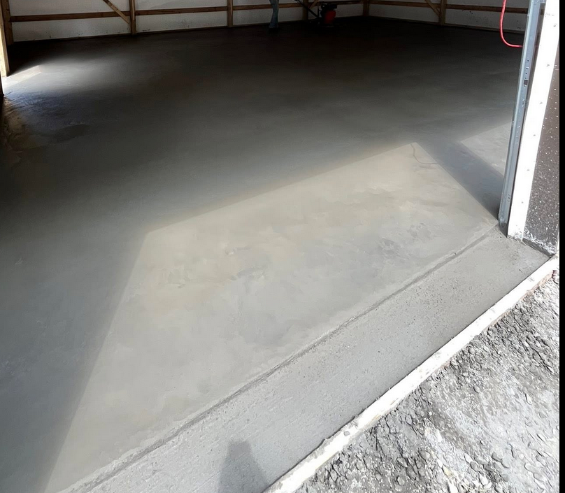 Freshly poured smooth finish concrete garage floor in Calgary by Concrete Star