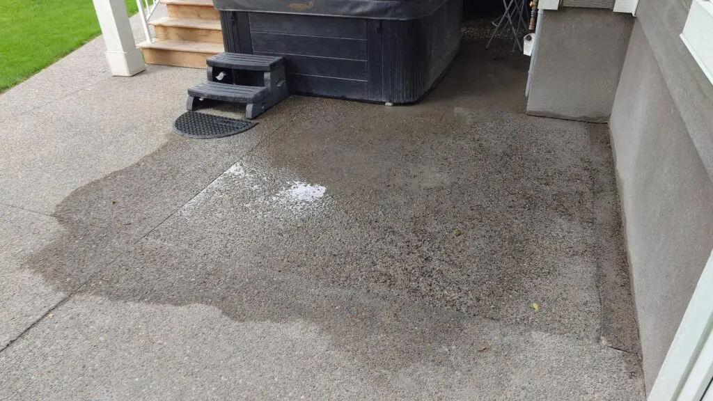 exposed-aggregate-patio-hottub Exposed aggregate concrete patio with hot tub area installed by Concrete Star in Calgary