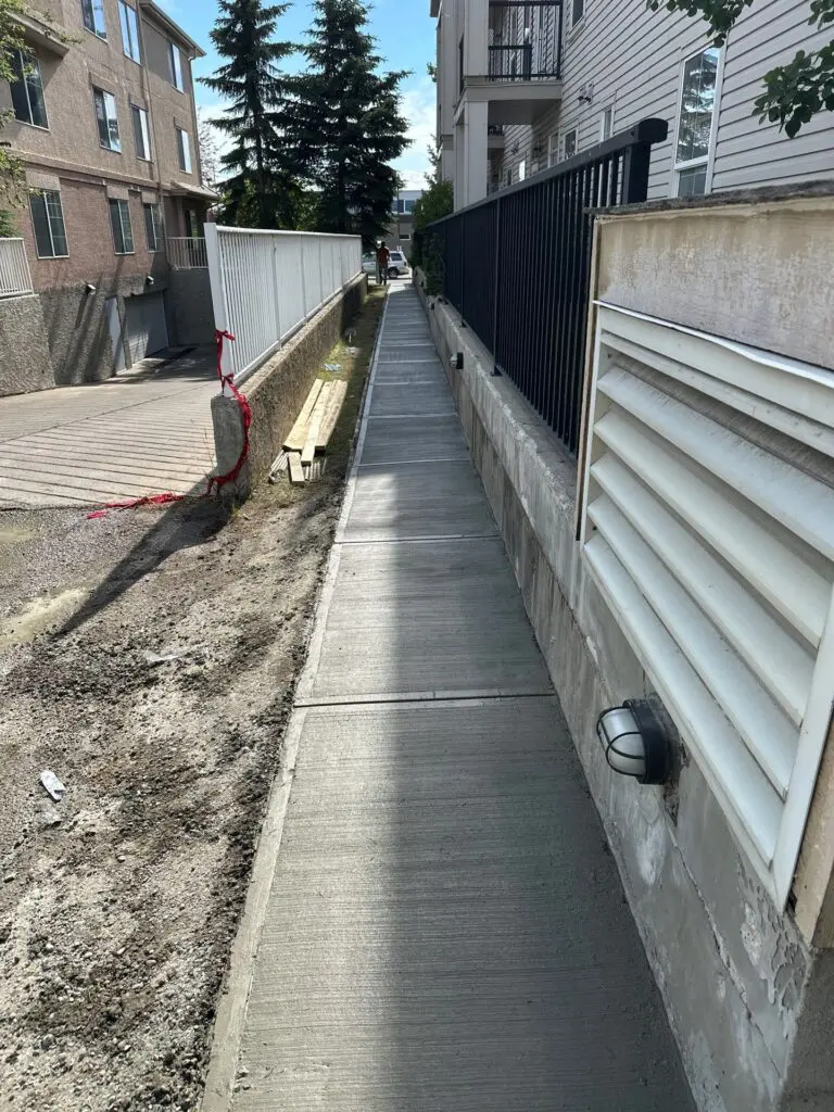 finished-sloped-sidewalk-north New sloped sidewalk poured with 32MPA fiber-reinforced concrete at the Solea Building, Bannister Rd SE, Calgary, AB