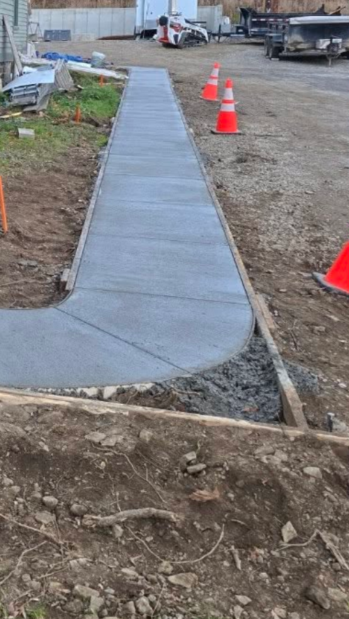 Freshly poured concrete walkway with smooth finish at a Calgary residential property by Concrete Star