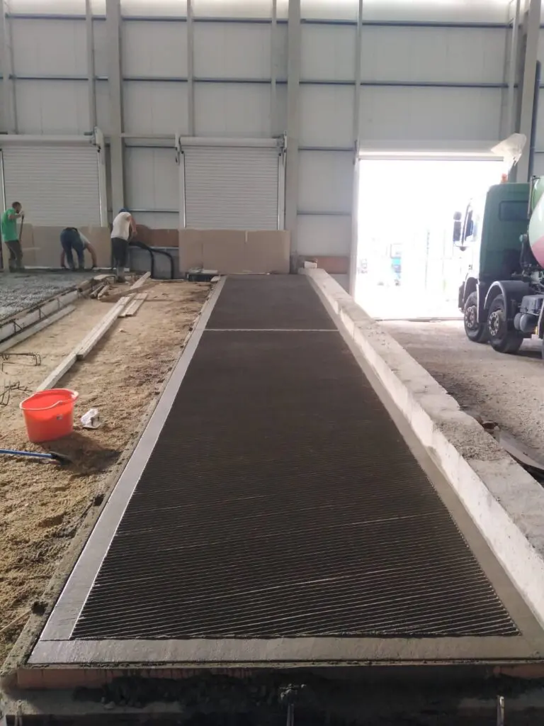 grooved-slab-pour-truck Concrete Star crew pouring a grooved slab with a cement truck on site in Calgary