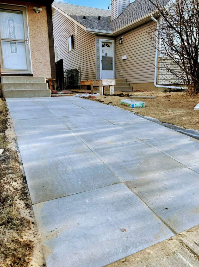 new concrete pavers restoring an old front house entrance walkway