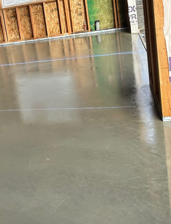 Power-troweled concrete garage floor with control joint in a new Calgary build by Concrete Star