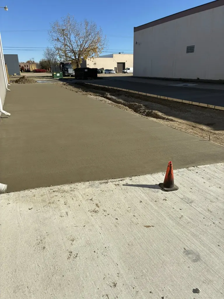 recently-poured_concrete-driveway-commercial recently poured concrete driveway behind commercial building