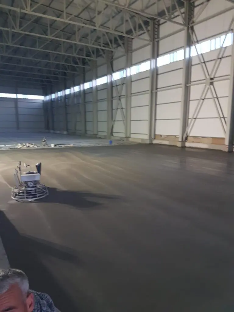 Power trowel finishing a commercial warehouse concrete floor by Concrete Star Calgary
