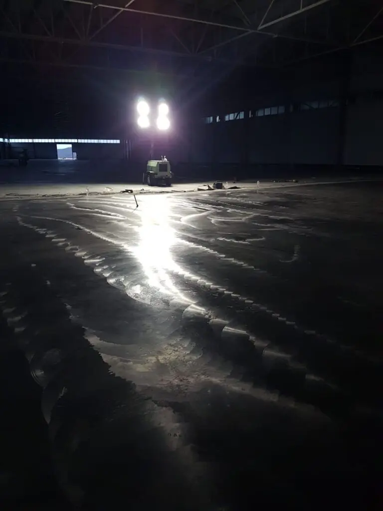 warehouse-night-pour-floodlights Concrete Star crew pouring a large warehouse floor at night under floodlights in Calgary