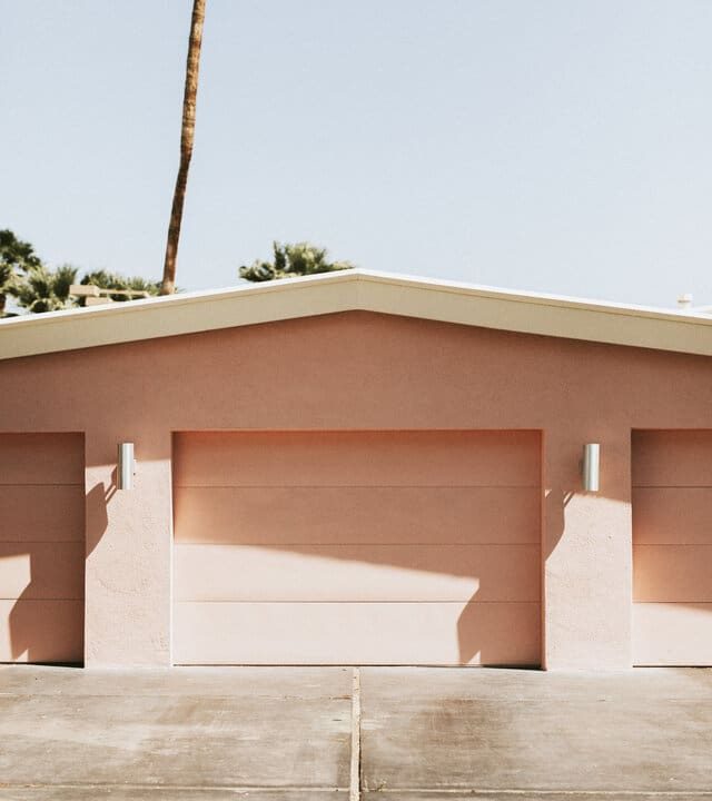 newly paved driveway at a three door pink garage